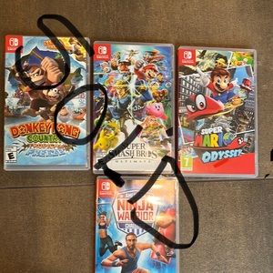 4 Nintendo switch games in the original box.